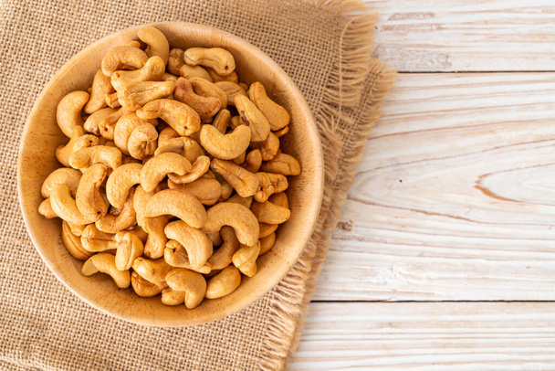 Cashew nuts in wooden bowl with copy space - Zdjęcie, obraz