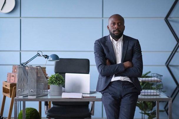 Handsome young businessman with folded arms in the office. self confident African American man with crossed hands portrait. Business, success, people, office lyfestyle concept - Photo, Image