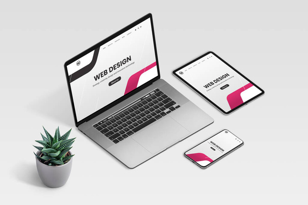 Web design studio promo page on laptop, tablet and phone display concept. Isometric view of desk with plant decoration - Photo, Image