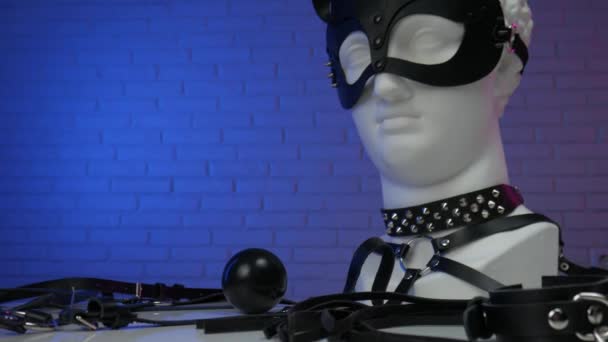 Cabeza de yeso de David en accesorios BDSM máscara látigo cuello de cuero y cinturón - Imágenes, Vídeo