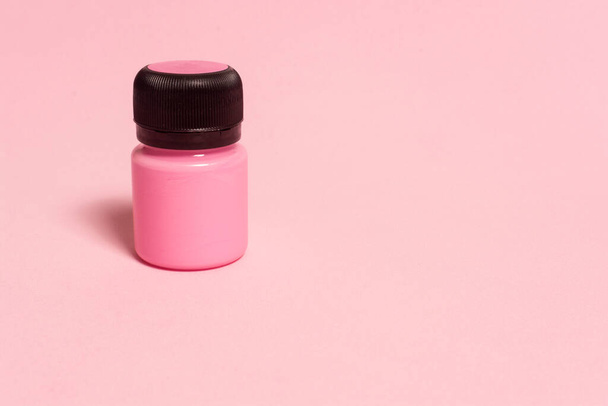 tin of pink color acrylic paint on pink background with copy space for your text. - 写真・画像