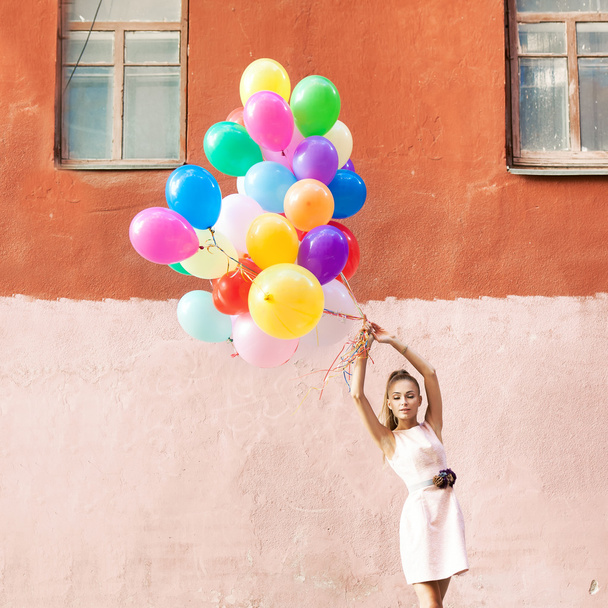 beautiful lady in retro outfit holding a bunch of balloons betwe - Φωτογραφία, εικόνα