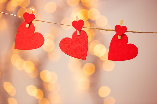 Happy Valentine day background with red hearts hang with clothespin on rope with bokeh background, romantic design, greeting card or copy space - Photo, Image