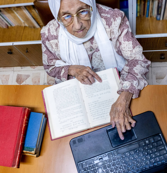 Arabia muslimi nainen käyttää kannettavaa tietokonetta lukemiseen E-kirjoja nad surfing internet - Valokuva, kuva