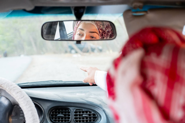 Arabic muslim couple in the car driving - Фото, изображение