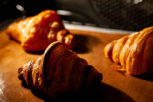 Baking croissants in an oven. - Photo, image