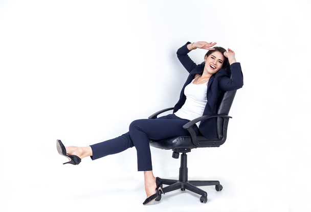 Happy successful business woman in office chair on white background - Foto, afbeelding