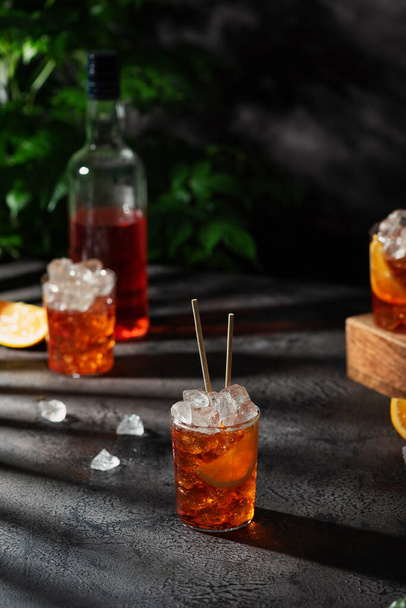 Bar conceprt. Summer Italian cocktail aperol with ice and orange, selective focus image - Foto, Bild