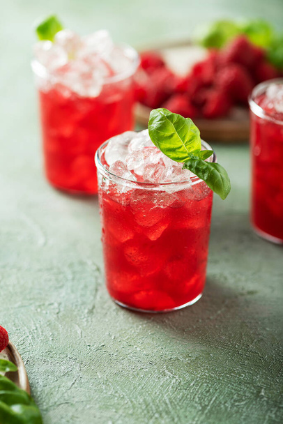 Fresh raspberry cocktail with basil and ice, selective focus image - Фото, изображение