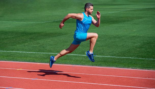 sportsman runner outdoor. health care. energy. muscular guy run to success. man running on stadium. sports and healthy lifestyle routine. sport workout. male athlete do morning exercise - Photo, image