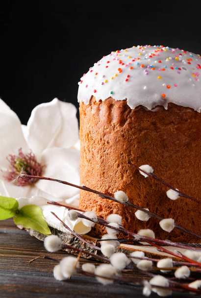 easter cake with willow twigs and a white magnolia flower on a dark background - Fotografie, Obrázek