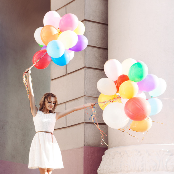 schöne Dame im Retro-Outfit mit einem Bündel Luftballons auf dem Kopf - Foto, Bild