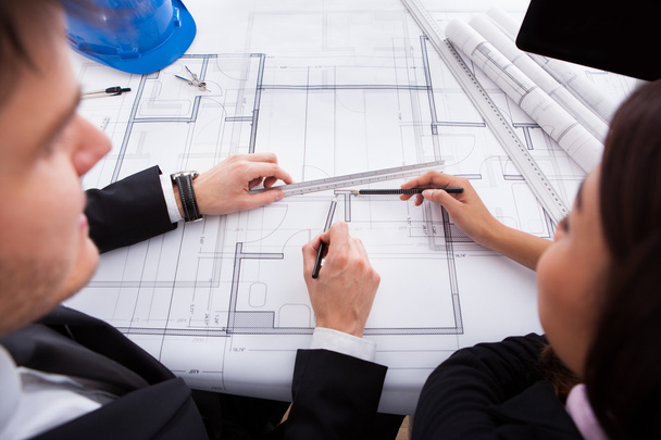 Architects Working On Blueprint At Desk - Photo, Image