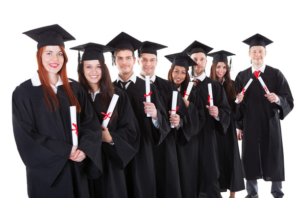 Graduate students standing in row holding diplomas - 写真・画像
