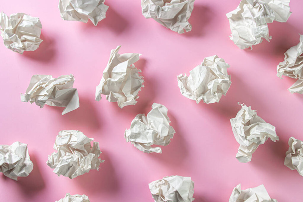 Crumpled paper on a pink background. A pile of crumpled paper. Creative crisis. Lack of ideas - Photo, Image