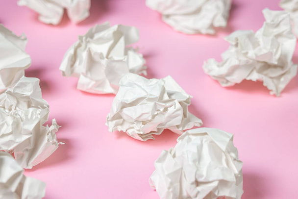 Crumpled paper on a pink background. A pile of crumpled paper. Creative crisis. Lack of ideas - Foto, imagen
