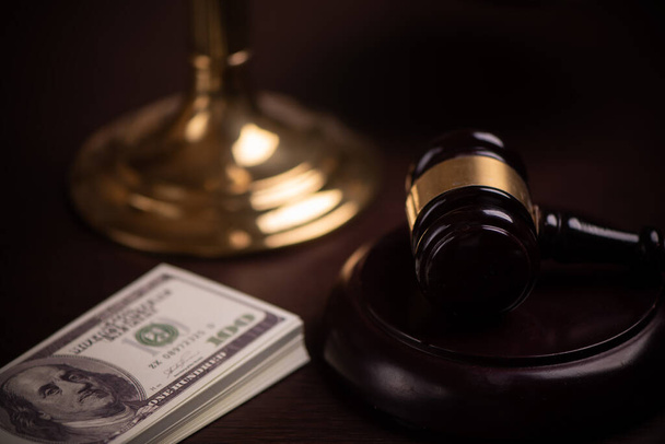 Judge gavel and money on brown wooden table concept close up - 写真・画像