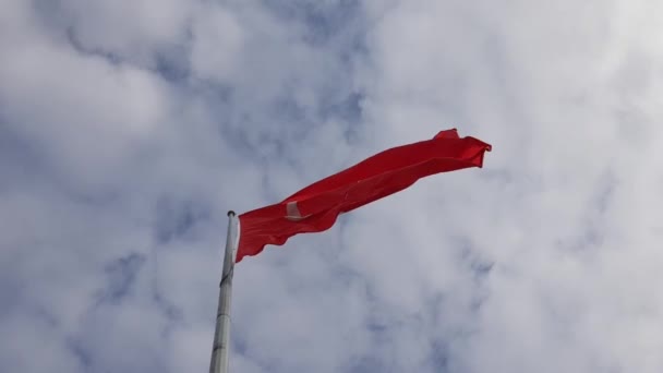 Turkish red flag waving by wind in blue sky with white clouds. National symbol of Turkey - Footage, Video