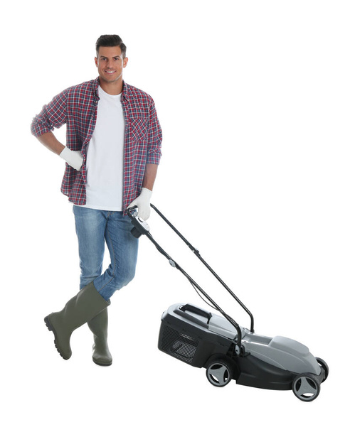 Man with modern lawn mower on white background - 写真・画像