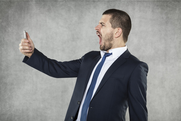 angry businessman shouts - 写真・画像