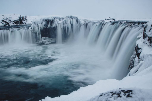 Panoramic snowy winter view of Godafoss Waterfall of the gods cascade in Laugar Fossholl Northern Iceland Europe - Foto, Imagen