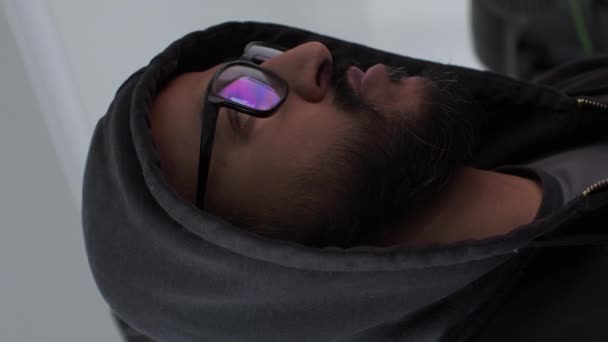 Hooded Adult Male With Computer Screens Reflected In Eye Glasses. Vertical Video, Locked Off, Low Angle - Footage, Video
