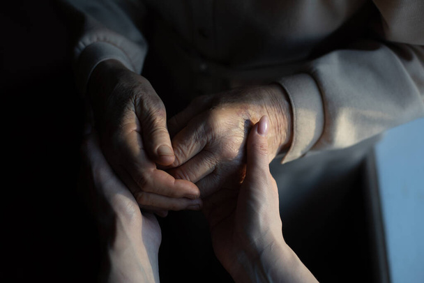 Unrecognizable grandmother and her granddaughter holding hands. - Photo, Image