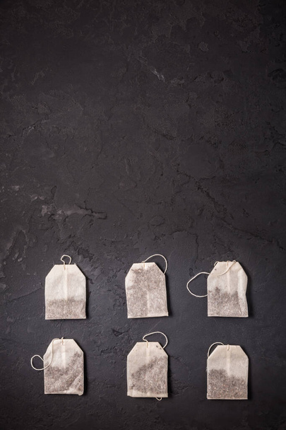 Assorted tea bags on black stone background - Photo, Image