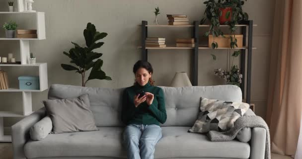 Woman read great news by sms celebrates moment feels excited - Filmagem, Vídeo
