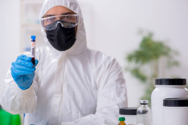 Young male chemist working in medicine lab - Фото, изображение