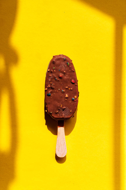 chocolate ice cream on the yellow background - Photo, image
