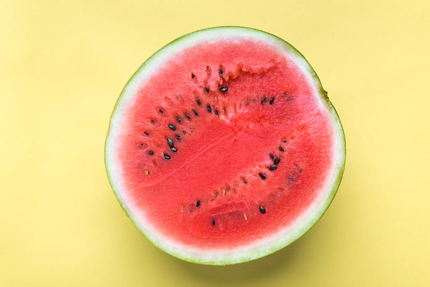 Fresh watermelon slice, fruit on yellow color background - Foto, afbeelding