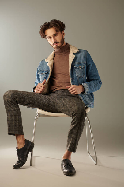 Men's fashion. Full length portrait of a handsome brunet man posing at studio in trendy casual clothes. Denim style. - Фото, изображение