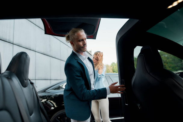 Young caucasian businessman examining new car - Photo, Image