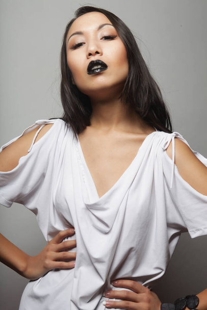 Beautiful sensual asian woman model with black lips posing in fashionable white dress - Foto, imagen