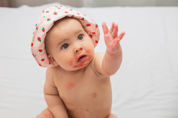 cute stained by strawberry baby reaching hand for her parents  - Photo, Image