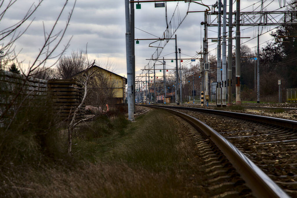 Railroad tracks next to a station in the outskirts of an italian town in winter - Photo, Image