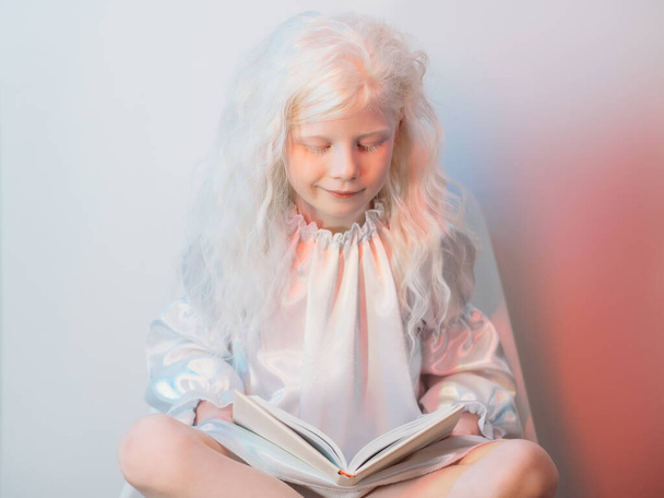 kid hobby story time blonde girl reading book - Fotoğraf, Görsel