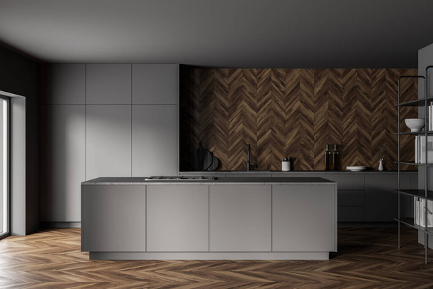 Interior of stylish kitchen with gray and wooden walls, wooden floor and gray island. Cupboards with built in sink and cooker. 3d rendering - 写真・画像