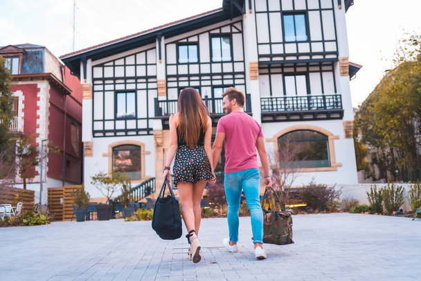 A Caucasian couple arriving at the hotel for their romantic vacation. Summer lifestyle - Fotoğraf, Görsel