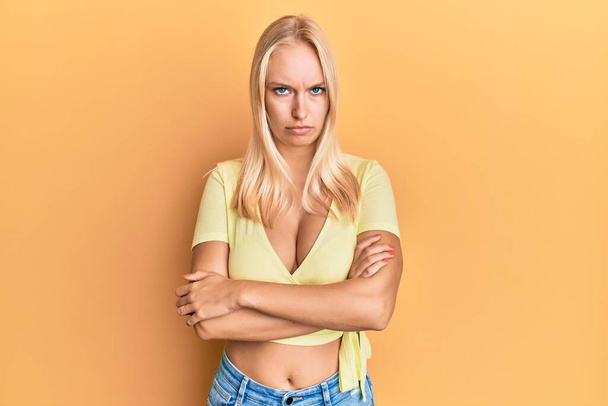 Young blonde girl wearing casual clothes skeptic and nervous, disapproving expression on face with crossed arms. negative person.  - Фото, зображення