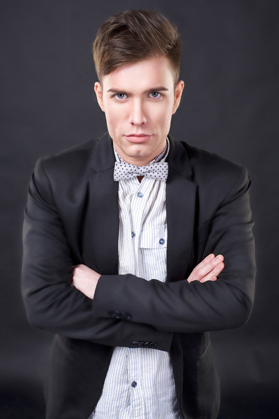 Young attractive man in a jacket and bow tie - Photo, Image