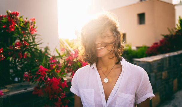 Beautiful Sunshine Girl Portrait. Happy smiling woman enjoying with smile and closed eyes on sunny summer day under hot sun - Zdjęcie, obraz