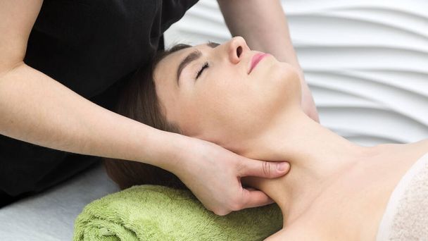 Neck and throat massage. Strong finger pressure the skin. - Valokuva, kuva