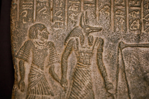 Profundidad de campo superficial (enfoque selectivo) e imagen de primer plano con jeroglíficos egipcios en una réplica histórica. - Foto, Imagen