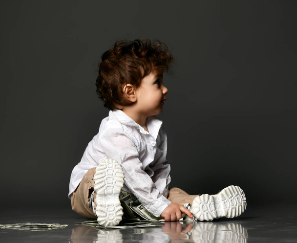 Fashion baby playing with paper money isolated shot - Φωτογραφία, εικόνα
