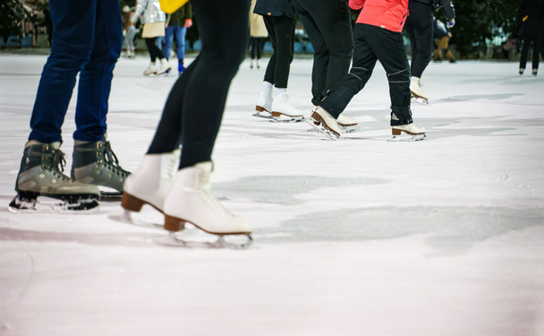 People ice skating on the ice rink in winter. - Foto, imagen