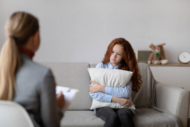 Child Psychologist. Sad teen girl having consultation - Photo, Image