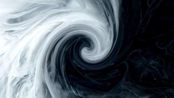 Black ink churns slowly in water. Abstract swirl background - Footage, Video