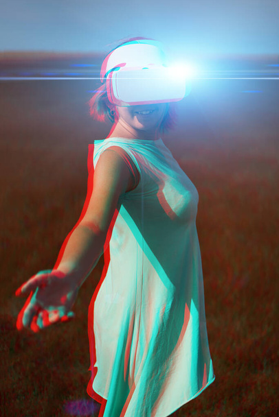 Woman goes into virtual reality using virtual reality headset. Image with glitch effect. - Фото, изображение